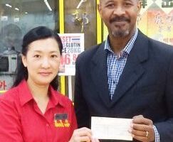 Eva of Wing Yip Wing and Andrew of the GLFB at cheque-presentation