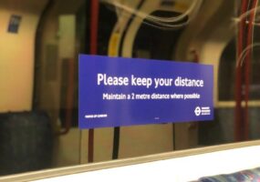 social distance sign inside a tube carriage