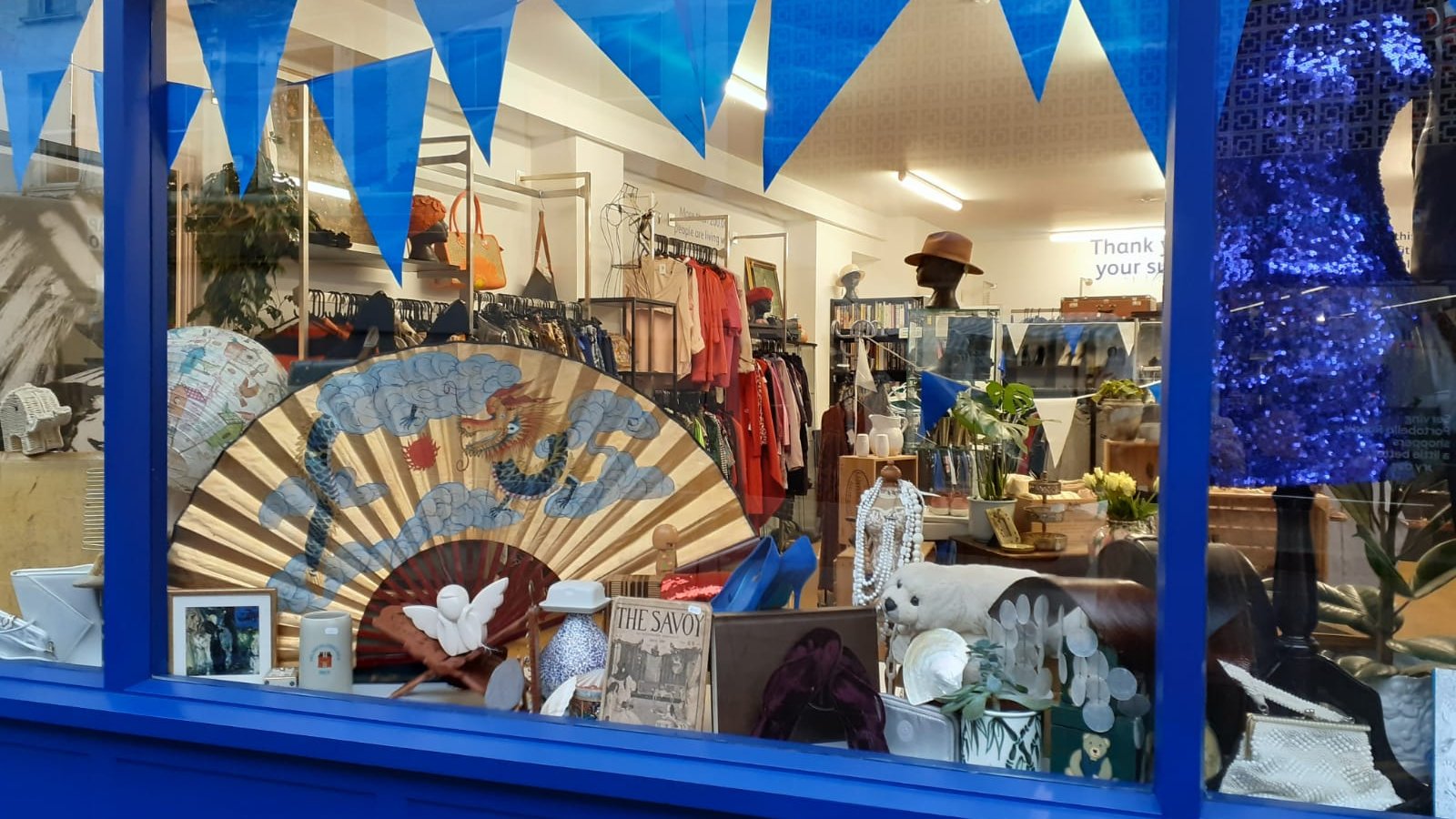 Vision Foundation charity shop window showing various items from the inside
