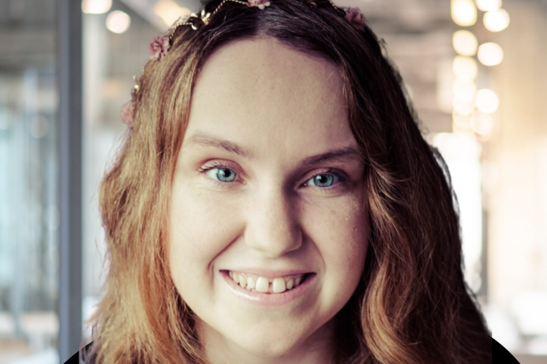 A headshot of Kerry Firth. She is wearing a headband with pink flowers in it.